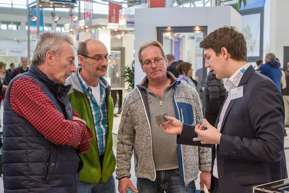 Kai Kegelmann erläutert interessierten Besuchern der IHM Internationalen Handwerksmesse in München den Metall-3D-Druck